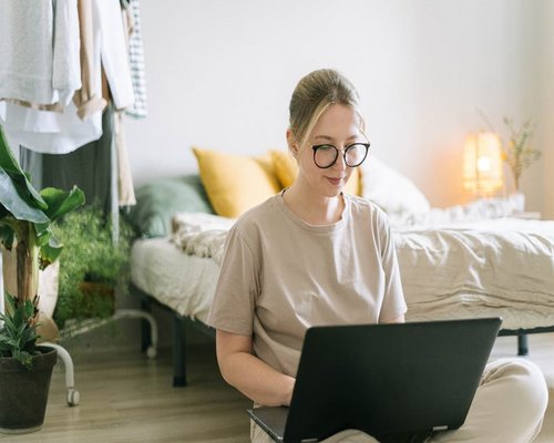 Woman working comfortably on laptop with natural light